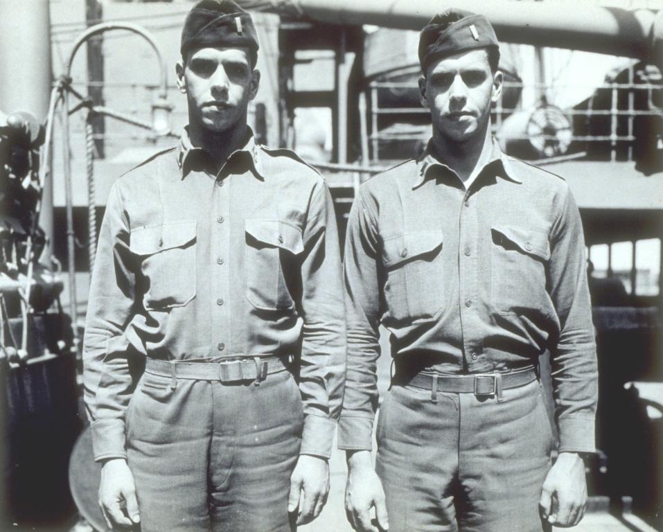 C1:002     Twin soldiers, tank destroyer casuals, Pier 5. Left to right: Lt. Fred A. Hurdman, 0-1823004; Lt. Ernest D. Hurdman, 0-1823003; home Chittenaugo, New York; 29 years of age; had served for 7 years together, first in the National Guard, living in the same tent, and since January 2, 1941, in the Army of the United States. They are identical twins and were born October 6, 1913. Their mother is Mrs. Ed Hurdman. They sailed May 9, 1943, on HR-190, SS NEO HELAS, from Pier 5, Newport News, for BLOT. May 8, 1943 (LVA sc_05_img10)