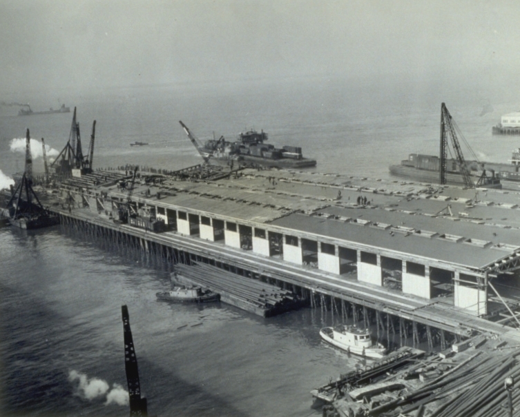 C1:002    Overall view of Pier 8, HRPE, showing progress of reconstruction to date. The Pier was totally destroyed by fire on the night of 17 December 1944. The fire was caused by spilling of gasoline from a fork-lift truck. February 20, 1945 (LVA sc_17_img104)